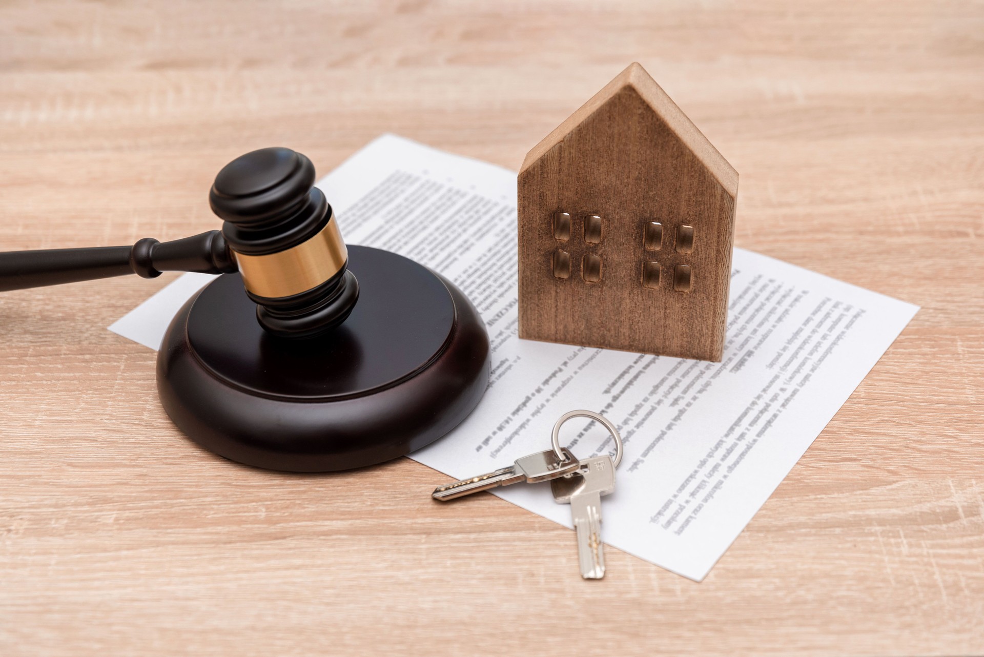 House Model with Judge's Gavel, Keys and Legal Document on wooden background, Property Law and rent concept